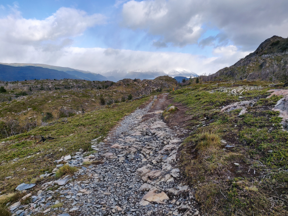 The hiking trail leading towards snowy mountains