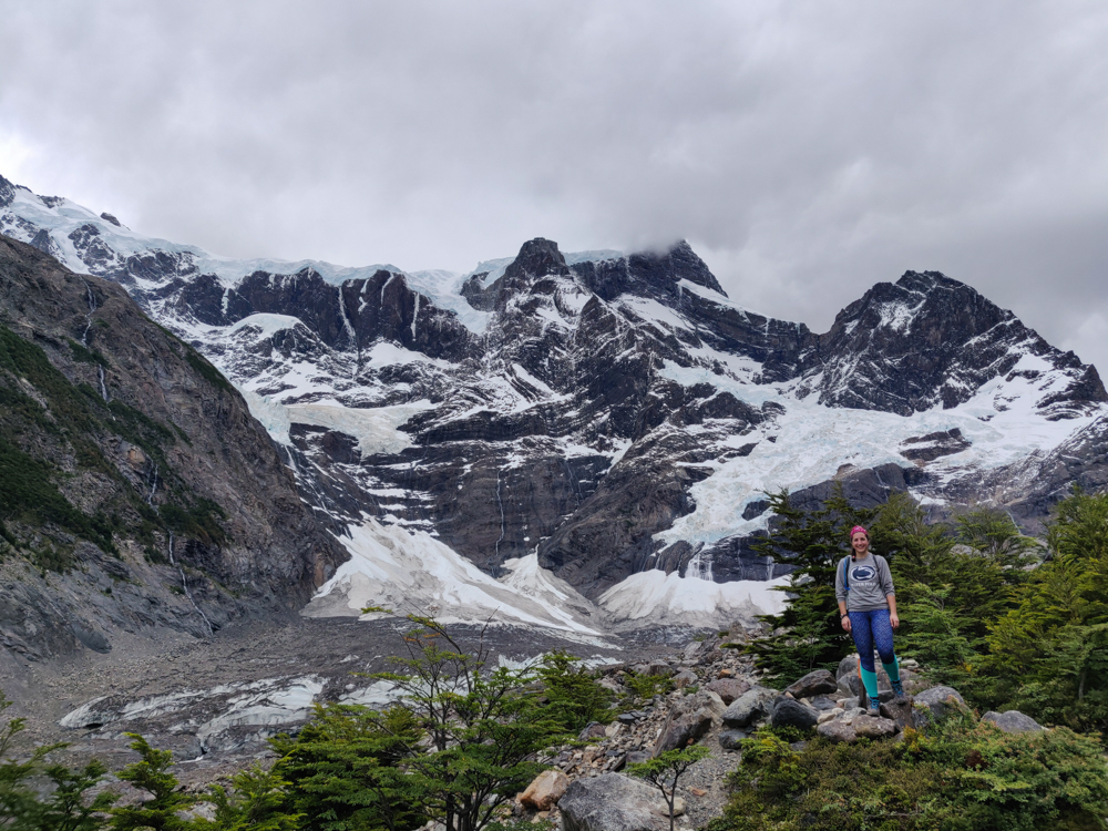 Me on a rock in front of the snow-covered mountain