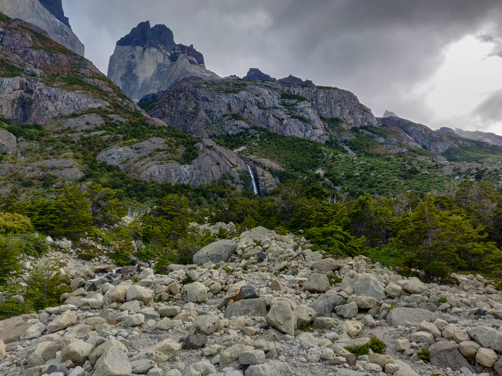 A rocky mountain peak with a little waterfall