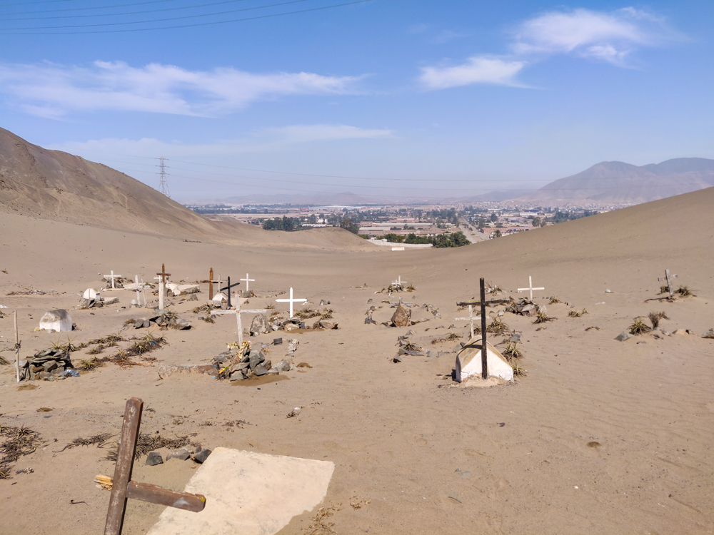 Cemetery crosses with our neighborhood in the background