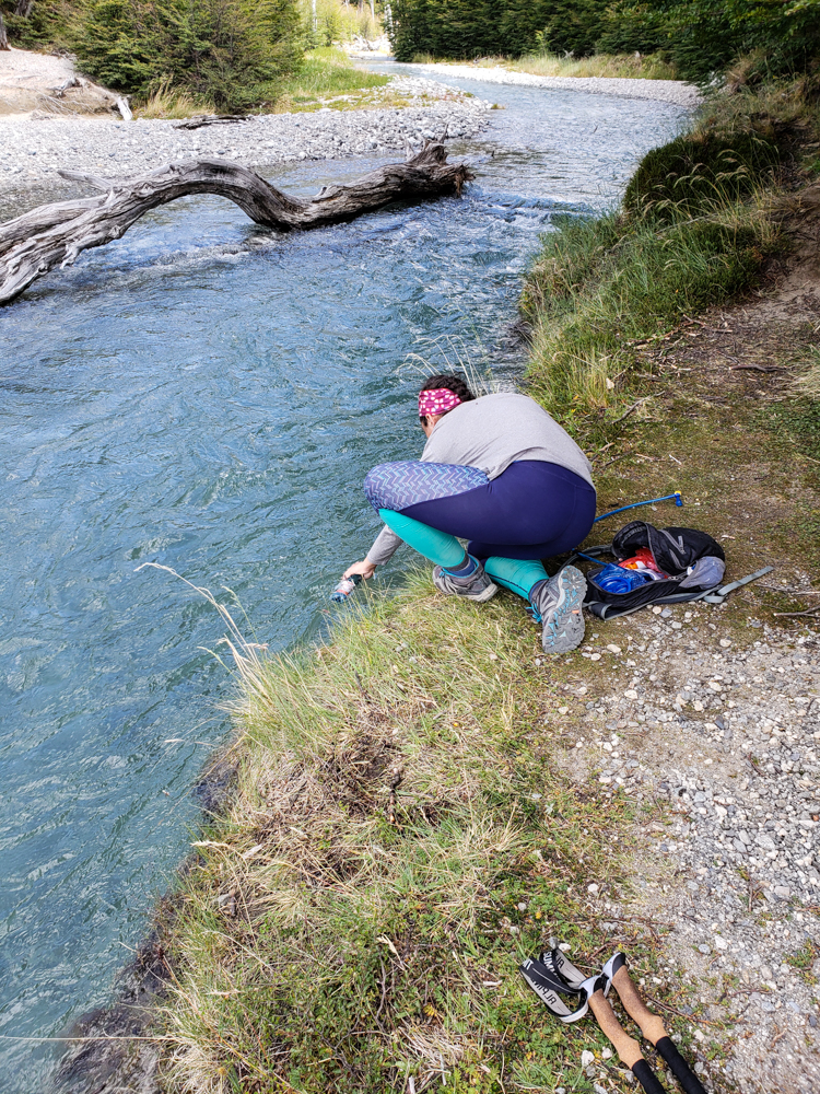 Me refilling my water bottle from the river