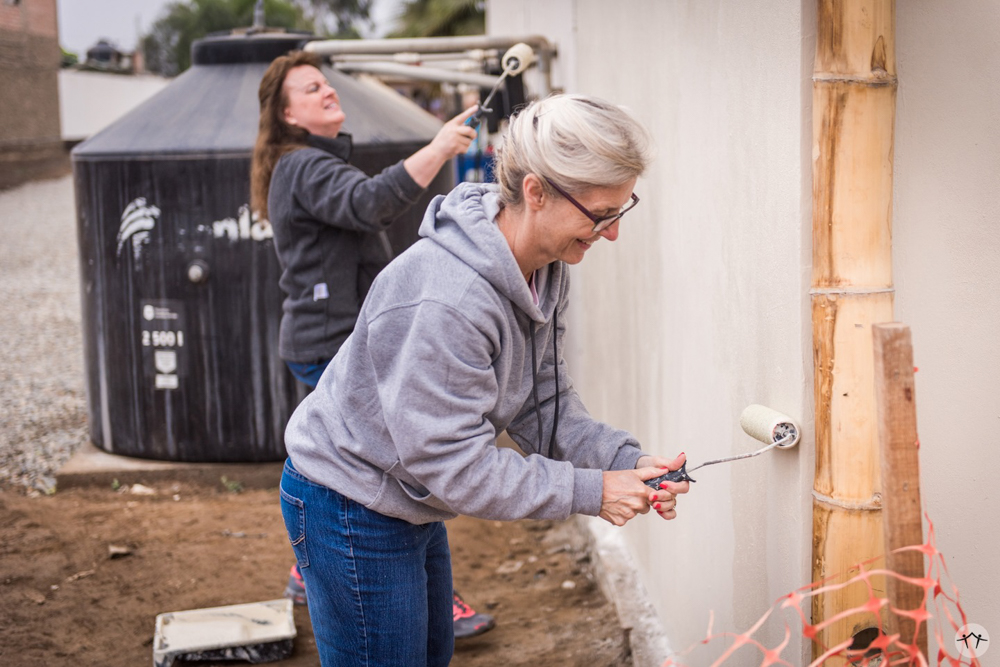 Some of the team members painting the workers' shed exterior