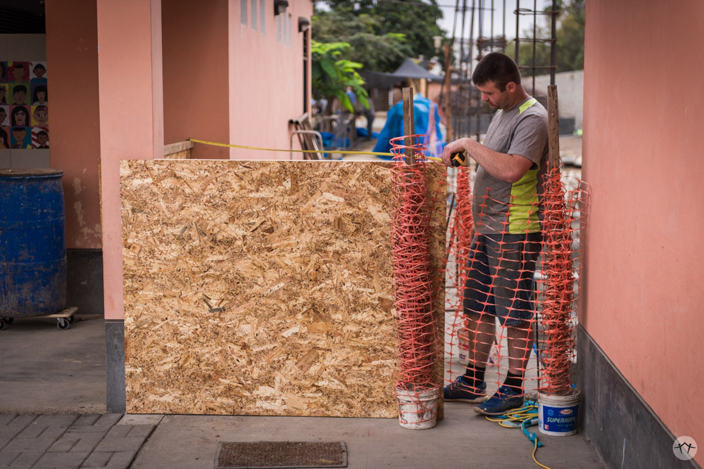 Team member taking some measurements for the construction barrier