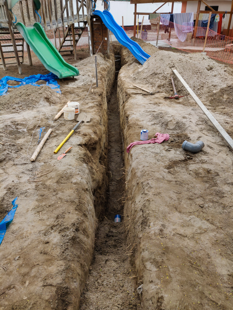 The septic trench stretching across the property and under the swing set