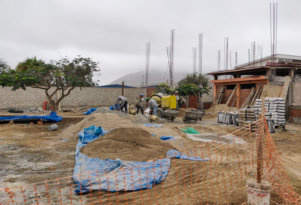 Construction guys preparing concrete for the floors