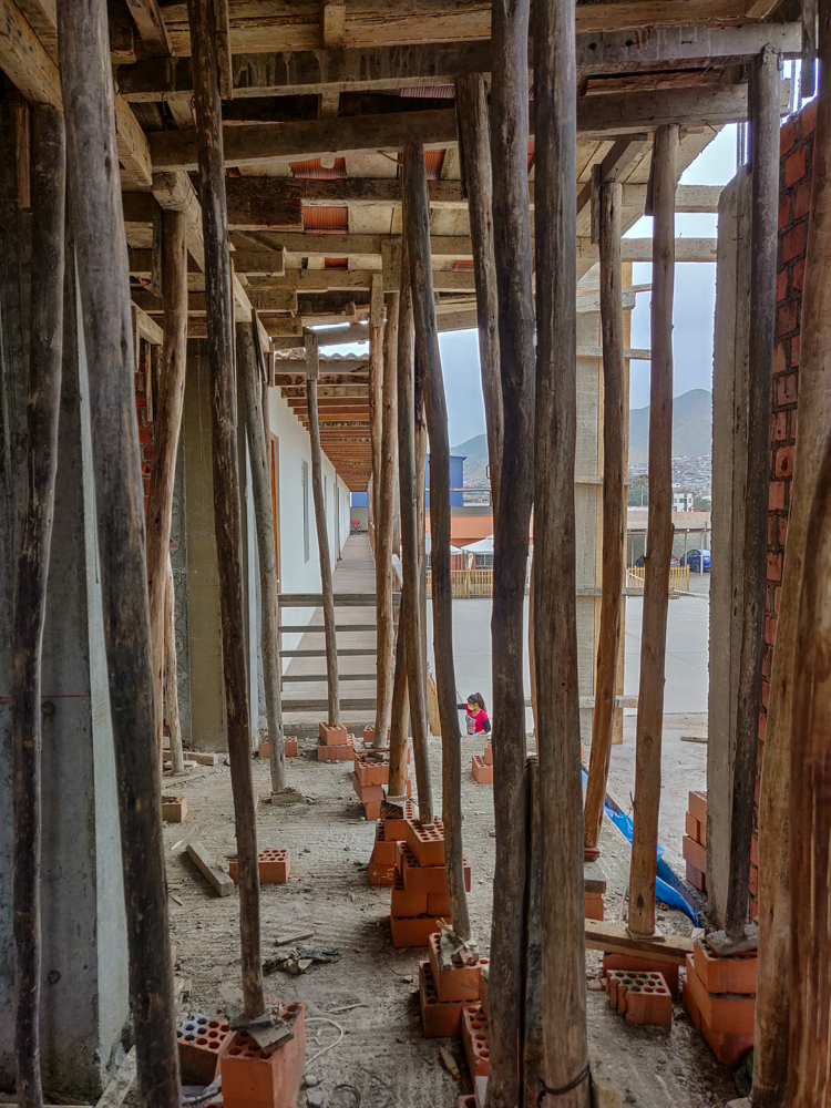 Looking through the roof supports at the existing building