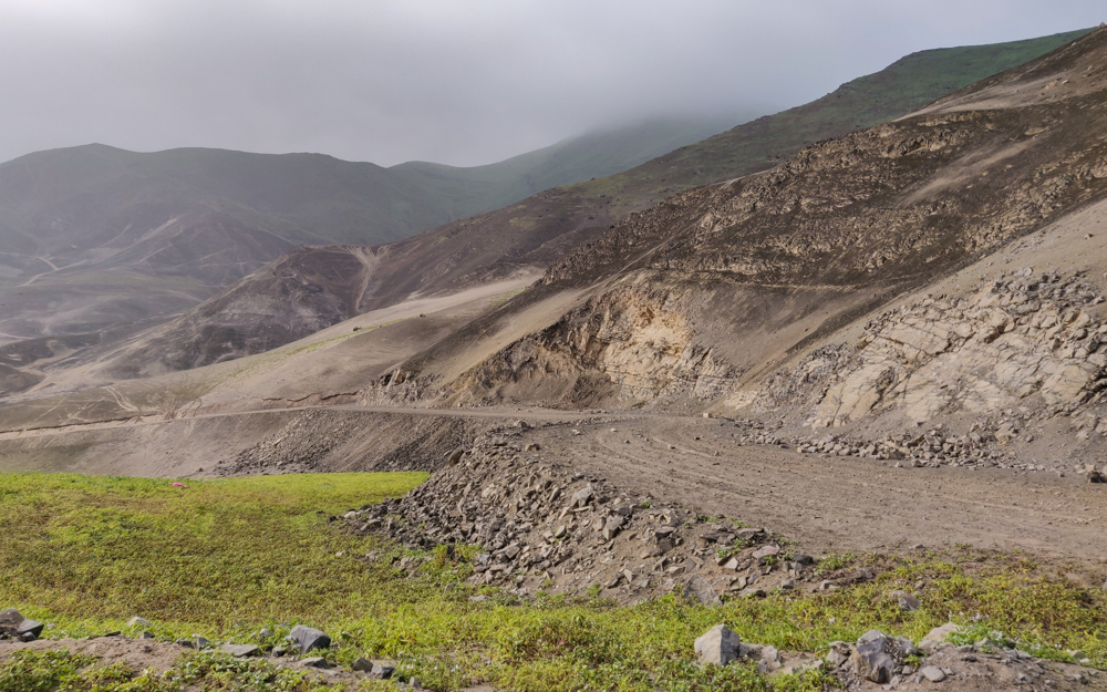 Road cut out of a brown mountain