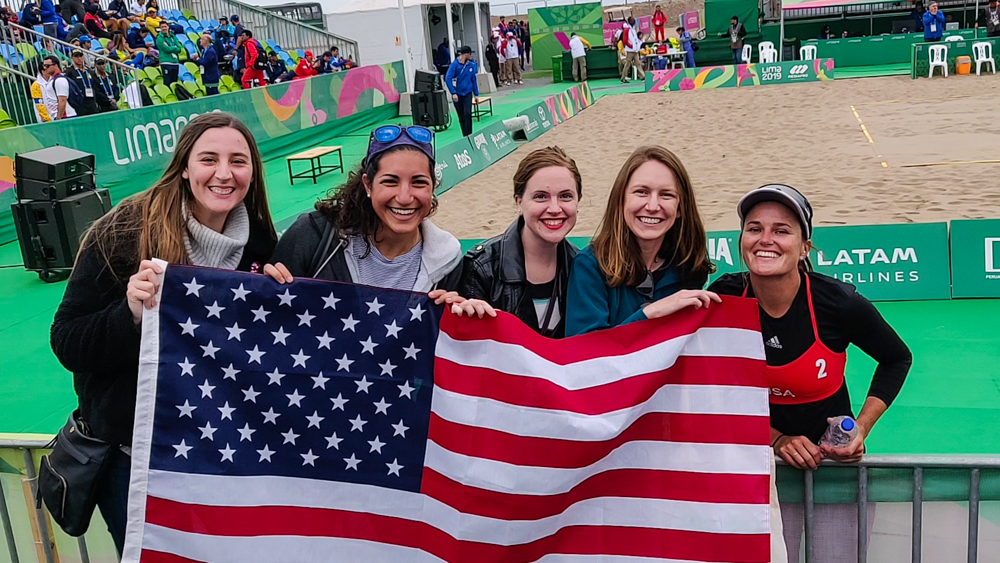 Us with an American flag at the beach volleyball court