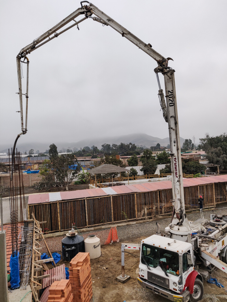 Pump truck unfurling its arm